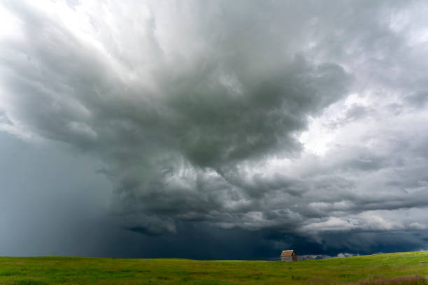 istock Ominous storm clouds gathering over a small abandoned building in the prairie 2202526648