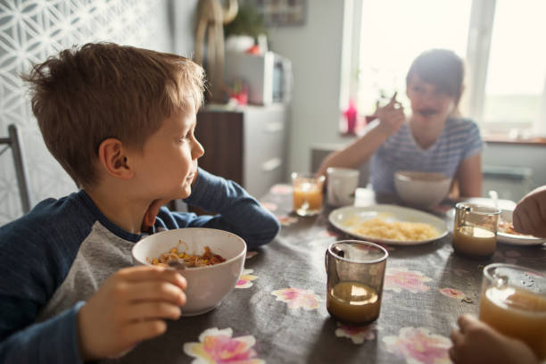 istock Children having lunch together at home 2202527534