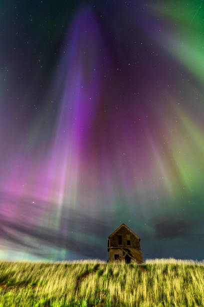 istock Abandoned house under a vibrant aurora borealis display 2202528061