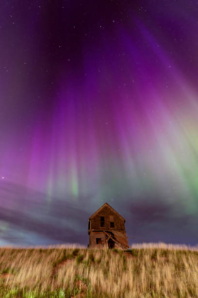 istock Abandoned house under majestic aurora borealis night sky 2202528066