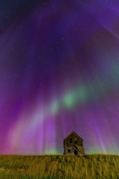 istock Abandoned farmhouse under majestic aurora borealis night sky 2202528074
