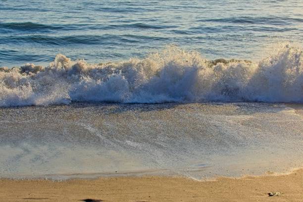 istock Ocean wave crashes onto the beach in Satellite Beach Florida 2202529729