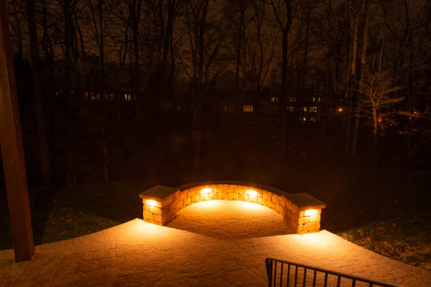 istock Illuminated Patio with Stone Wall at Night 2202530429