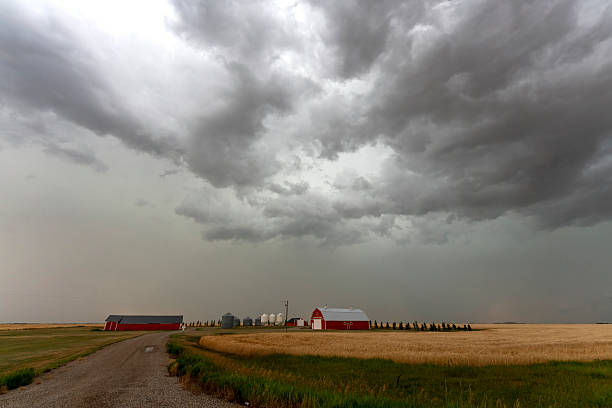 istock Storm clouds gathering over a farm in the prairie 2202530821