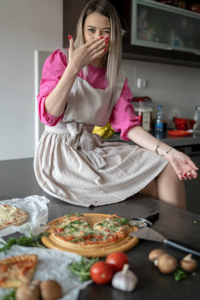 istock Beautiful young woman with pizza 2202530995