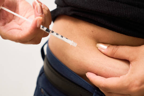 istock A diabetic young woman using insulin in stomach. Control diabetes. 2202531206