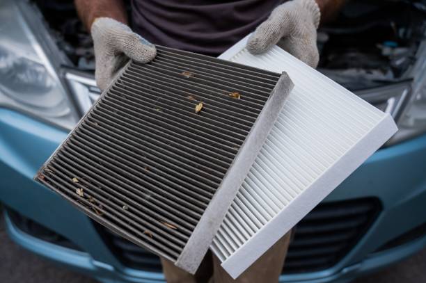 istock The master changes the cabin air filter of the car. 2202533584