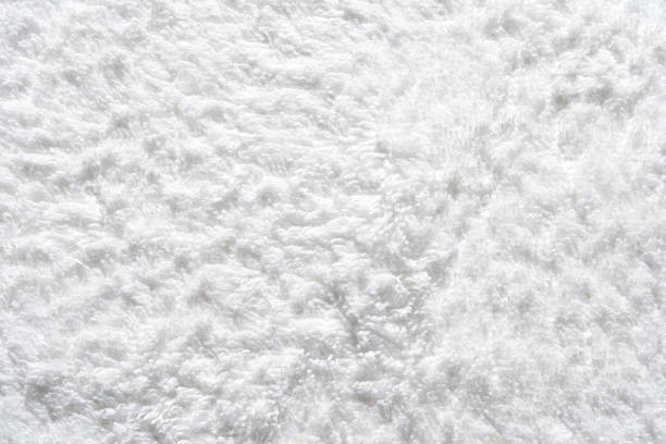 Close-up texture of soft fluffy white towel material perfect for design backgrounds.