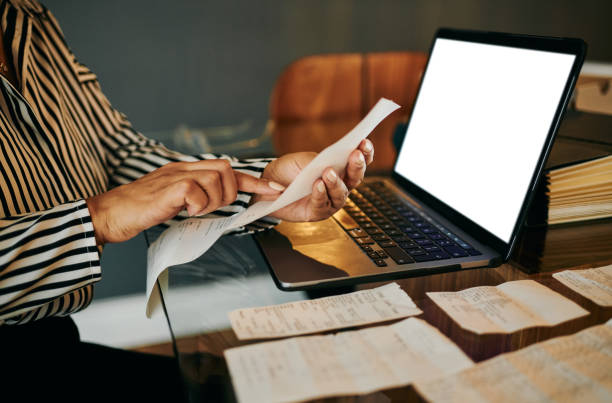 istock Reviewing Expenses at Home with Laptop and Receipts 2202535800