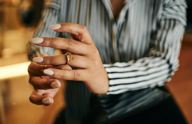 istock Woman Wearing Wedding Ring at Home 2202535804