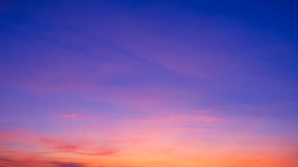 istock Twilight sky background with pink clouds on colorful orange and blue romantic evening sky after sundown 2202536870