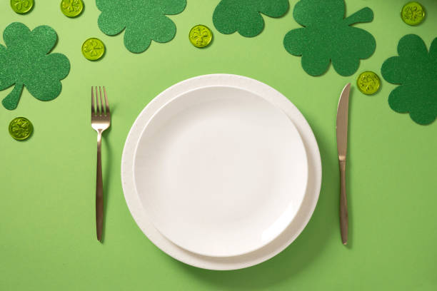 istock St Patrick's Day party table setting with decoration on green background. 2202539484