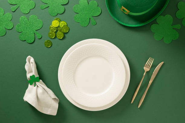 istock St Patrick's Day party table setting with decoration on green background. 2202539488