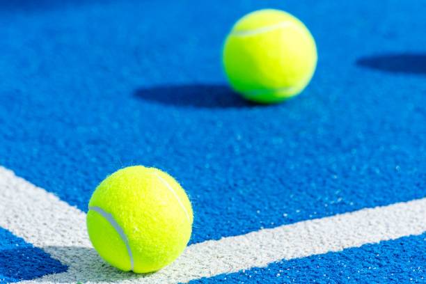 istock Two balls on a paddle tennis court. 2202544940