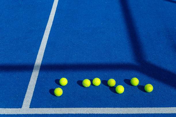 istock Eight balls on a blue paddle tennis court. 2202544942