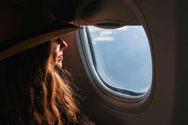Female Tourist Looking Out the Airplane Window