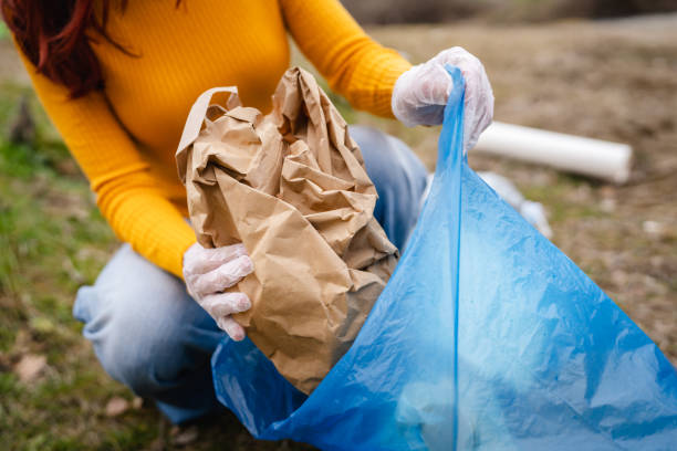 istock hands unknown caucasian teenagers picking up waste 2202555292