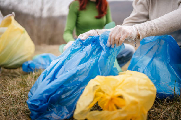 istock hands unknown caucasian teenagers picking up waste 2202556529