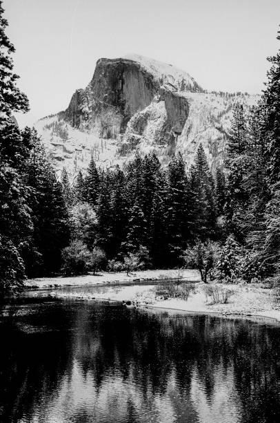 Wintertime view of Half Dome and Merced River, as seen from the Yosemite Valley floor.\n\nTaken in Yosemite National Park, California, USA.