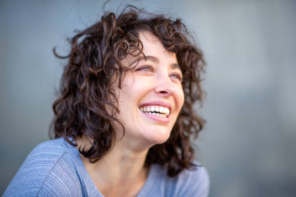 istock Cheerful young woman looking away and smiling 2202574082