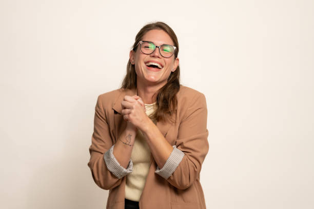 istock Young Professional Woman Laughing with Joy Against Neutral Background 2202574357