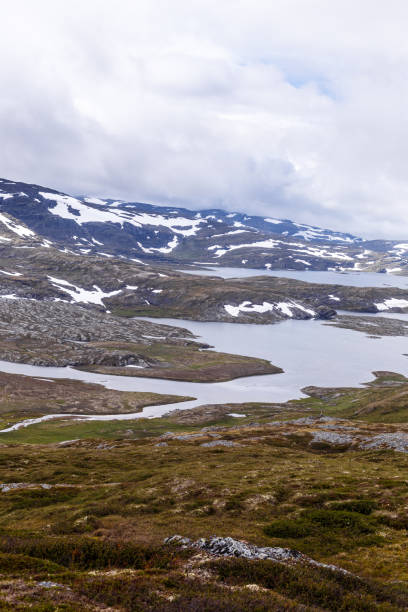 istock A Scenic Mountainous Landscape Featuring Snow-Capped Peaks and Serene Lakes Captured Under Dramatic Cloudy Skies in a Remote Natural Wilderness Area 2202574719