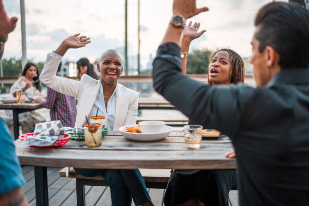 istock Diverse Group of Friends celebrating in an Eatery 2202575628