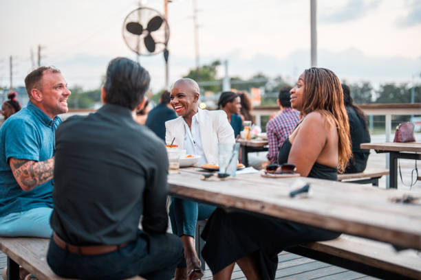 istock Diverse Friends Enjoying Sunset Dinner Outdoors 2202575630