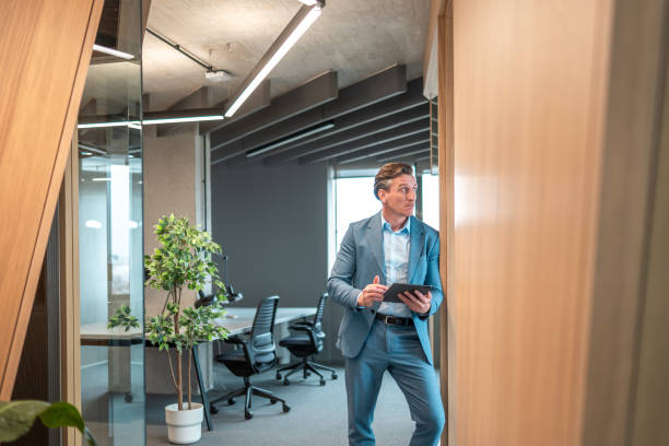 istock Senior Business Executive with Tablet in Contemporary Office 2202575697