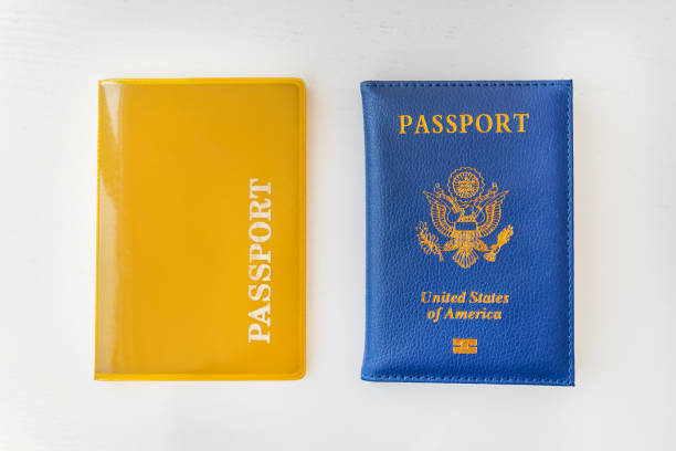 yellow Passport and Blue passport of USA United states of America on a white background of the table.. the concept of dual citizenship yellow Passport and Blue passport of USA (United states of America) on a white background of the table.. the concept of dual citizenship blue us passport cover stock pictures, royalty-free photos & images