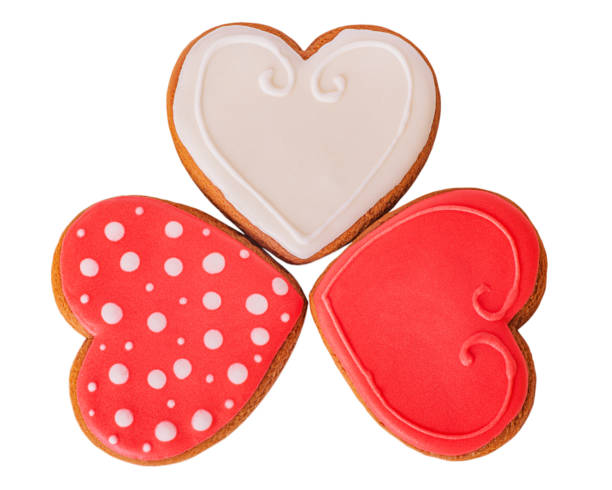 istock Three gingerbread cookies red, white and red with polka dots isolate on a white background. 2202576271