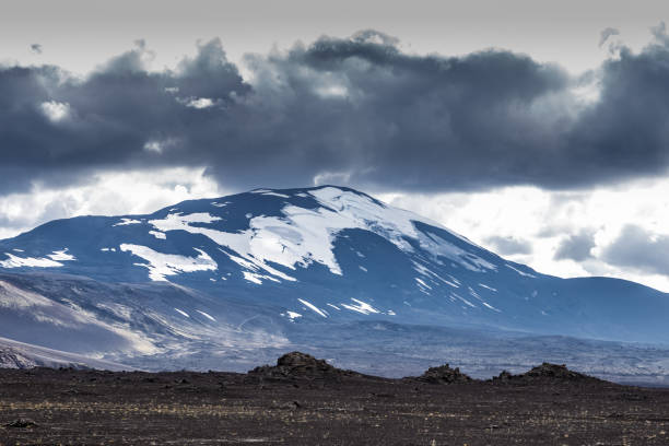 istock Breathtaking Mountain Landscape with Snow-Capped Peaks and Dramatic Clouds Surrounding the Rugged Terrain of a Volcanic Region 2202580277