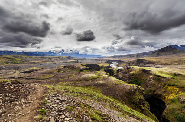 istock Majestic Landscape of Iceland's Rugged Terrain Highlighted by Dramatic Cloud Formations and a Meandering River Cutting Through the Breathtaking Scenery of Nature's Wonders 2202584972