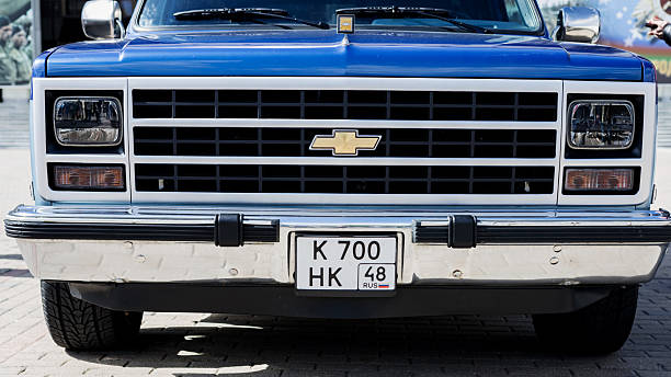 Minsk, Belarus, February 27, 2025 - Headlights and radiator grille retro old blue Chevrolet pickup truck