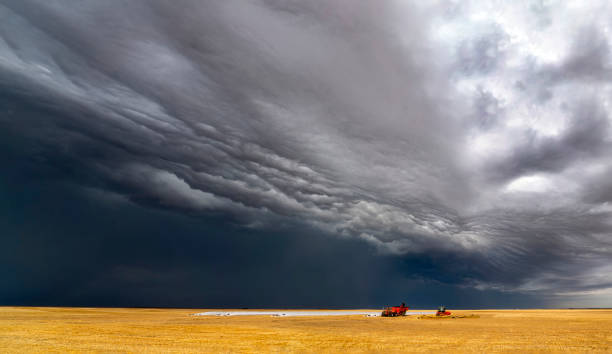 istock Shelf cloud approaching farm machinery working in a field 2202588216