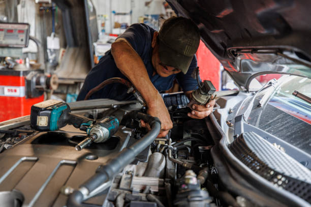 istock Meticulous mechanic resolves engine issues. Middle-aged Latino man performs automotive repair. 2202588982