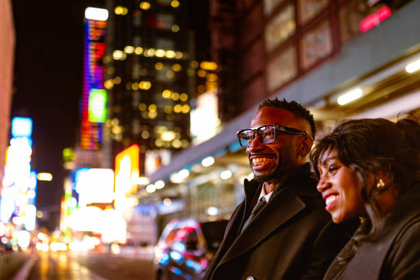 istock Couple Elegantly Dressed Going to Theatre in Times Square at Night 2202589042