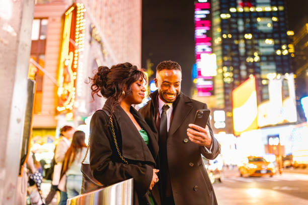 istock Elegant Couple Enjoying Night Out in Times Square 2202589043