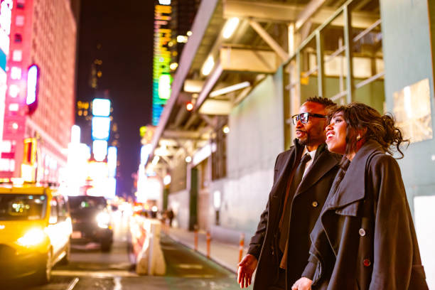 istock Elegantly Dressed Couple on a Theater Night in Times Square 2202589047
