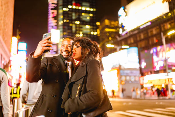 istock Elegant Couple in Times Square at Night 2202589055