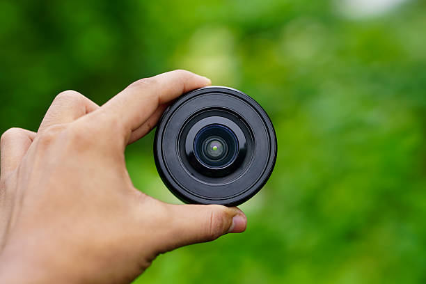 istock A Photographer Holds a Camera Lens 2202593321