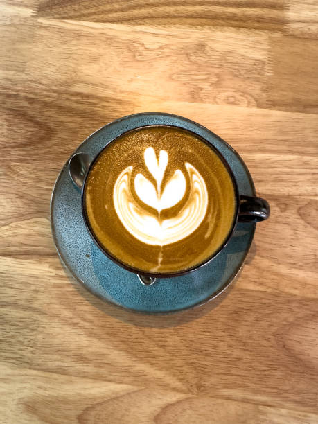istock Coffee cup with cappuccino on a wooden table 2202595316