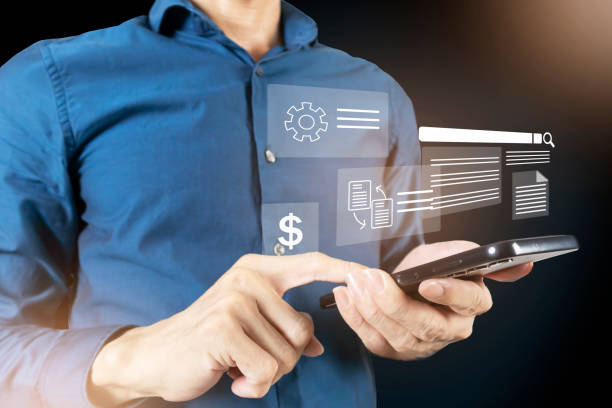 istock The concept of using mobile phones and technology, using mobile phones to check checklists of information and analyze returns or edit details of business investments. 2202597223