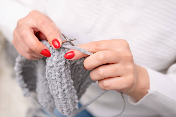 istock female hands knitting close up 2202606352