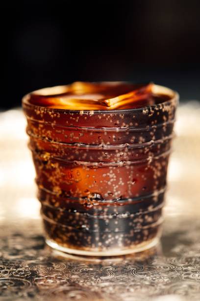 istock rocks glass with cola and big ice cube 2202607166