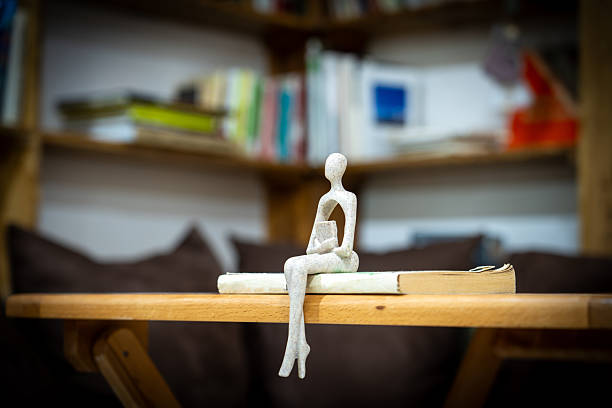 Seated figure with a book, seated figure
