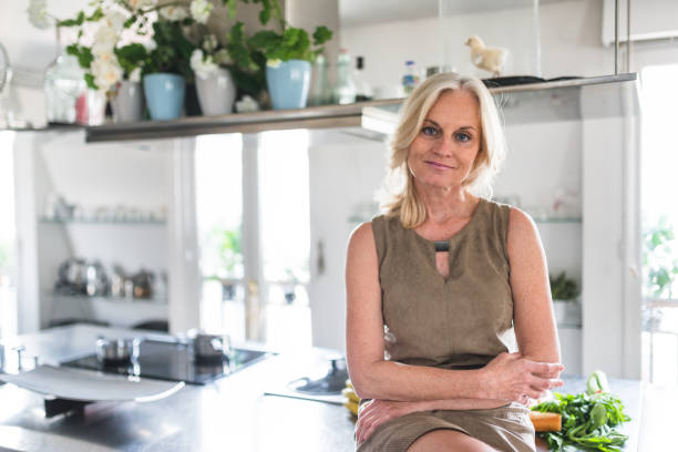 istock confidence woman standing in the kitchen at home 2202625998
