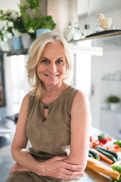 istock confidence woman standing in the kitchen at home 2202626019