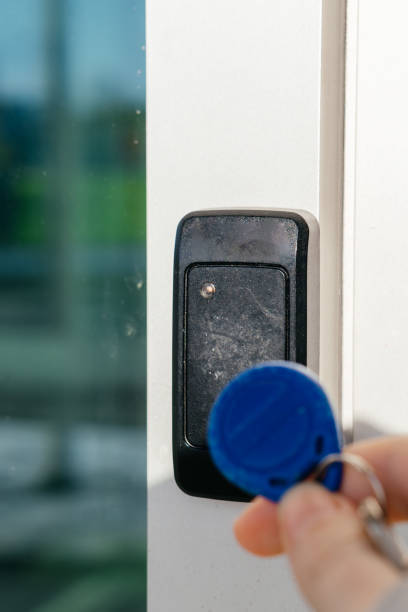 istock A person uses an RFID key fob to access a secure door via an electronic card reader, symbolizing modern security technology. 2202626838