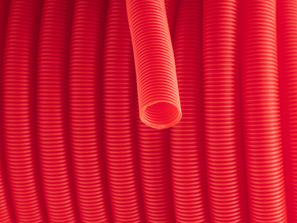 istock Plastic corrugated hose closeup. Red background. 2202629920